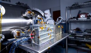 Spacecraft components configured for testing rest on a table.