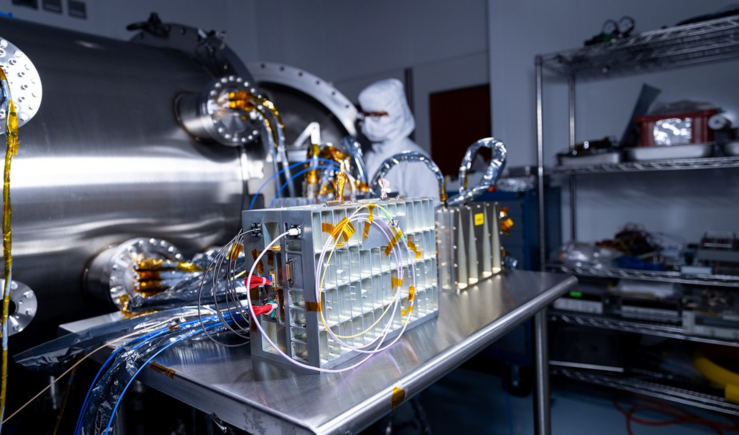 Spacecraft components configured for testing rest on a table.